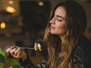 woman holding fork in front table